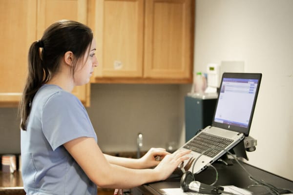 Staff member working on a computer at the facility