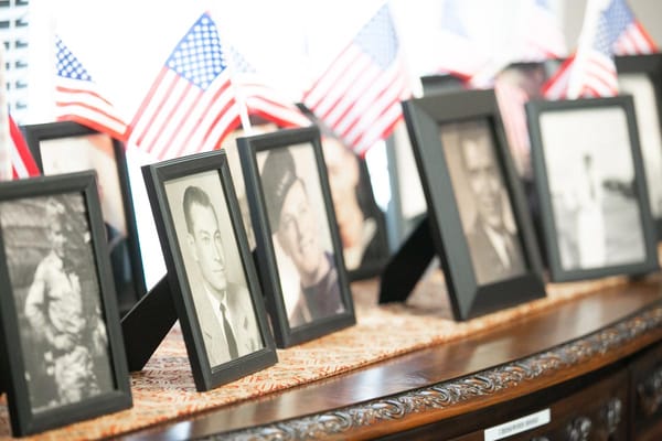 Framed portraits of residents alongside small American flags