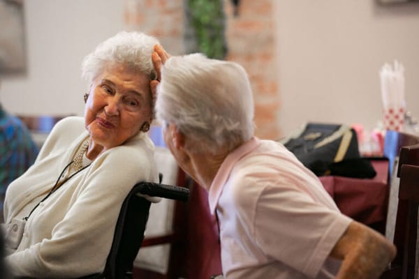 Two residents enjoying a conversation in a common area