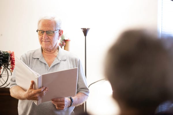 Senior resident reading a document in a well-lit room