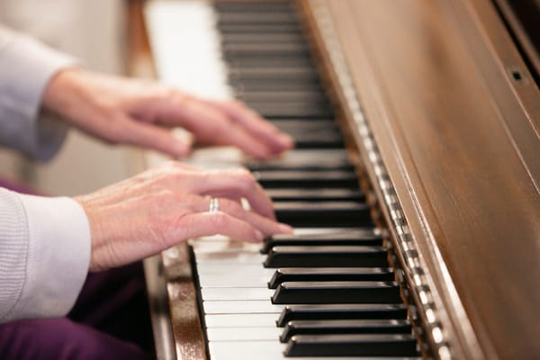 Hands playing a piano