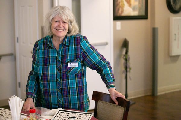 Resident smiling during a bingo game activity