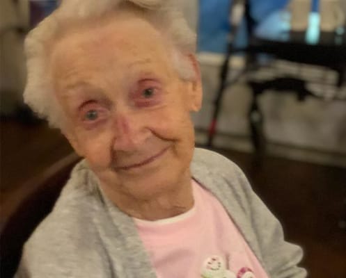 Smiling elderly woman in a social setting