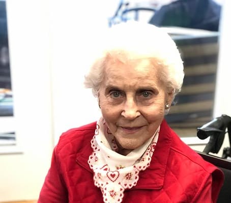 Smiling elderly woman in a cozy interior setting