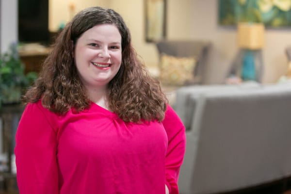 Staff member posing in a welcoming common area