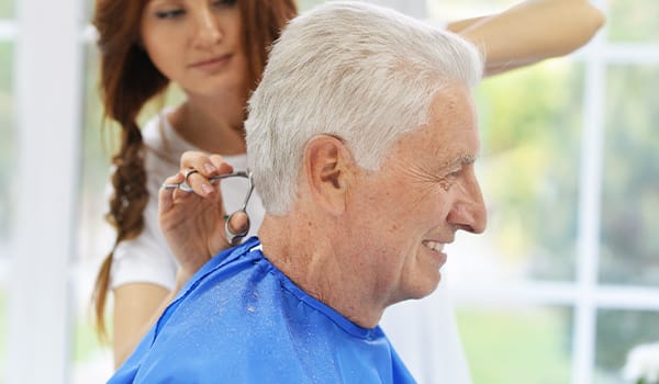 Senior getting a haircut in a salon