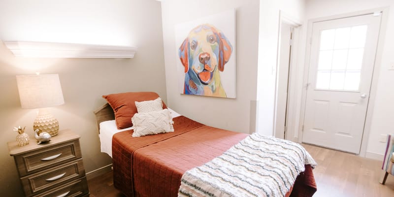 Comfortable resident room with warm decor and artwork