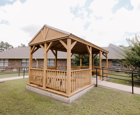 Wooden gazebo in a landscaped outdoor area