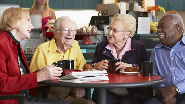 Residents enjoying coffee and conversation in a common area