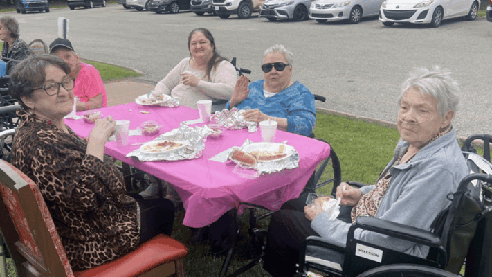Residents enjoying a meal at an outdoor gathering