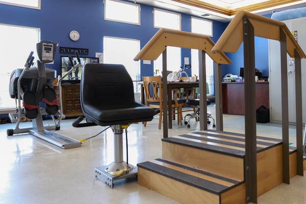 Interior rehabilitation space with equipment and stairs