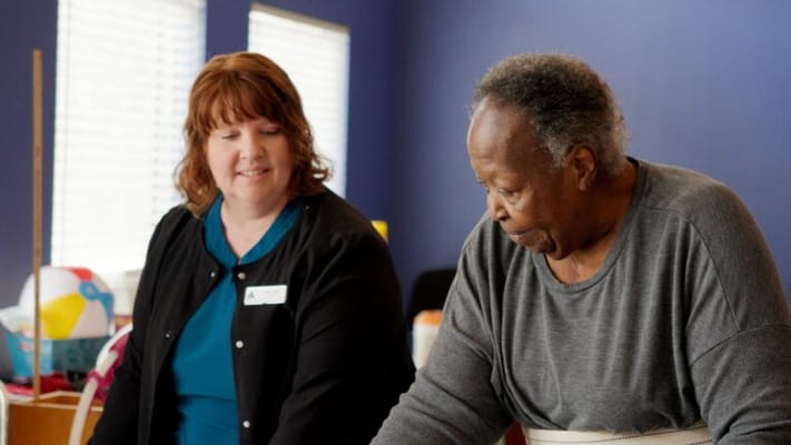 Staff member assisting a resident in an activity