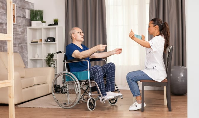 Therapist assisting a resident in a rehabilitation session