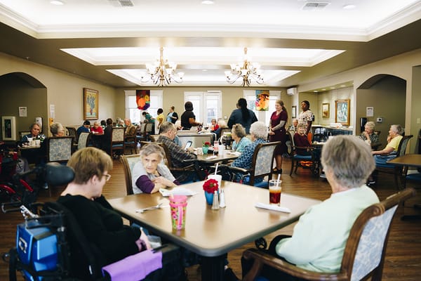 Residents enjoying a meal in a dining room