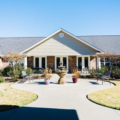 Outdoor view of the facility entrance with a fountain