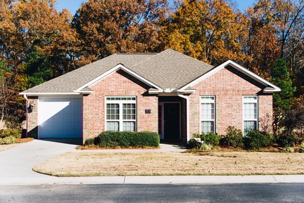 Exterior view of a brick house with a driveway