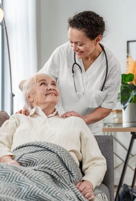 Caregiver smiling with a resident in a cozy living area