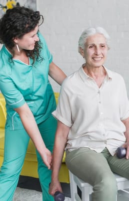 Staff assisting a resident with exercise in a bright room