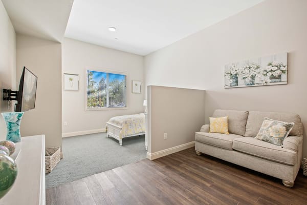 Bright interior view of a resident's room with a sofa