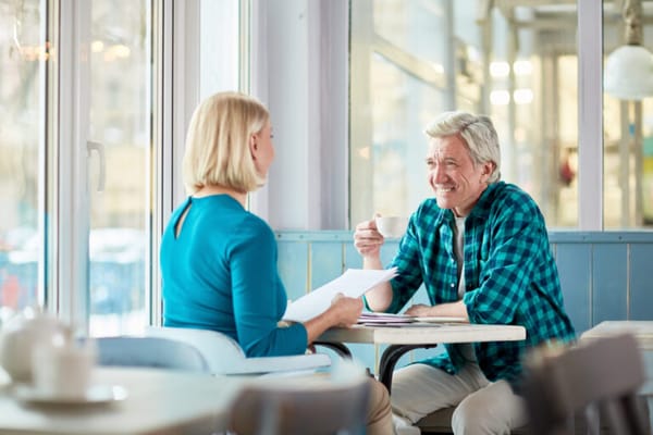 Residents enjoying coffee and conversation in a cozy café setting