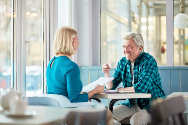 Residents enjoying coffee and conversation in a cozy café setting