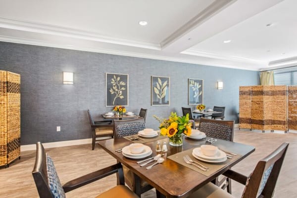 Well-decorated dining room with tables set for meals