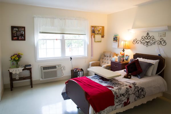 Cozy resident room with bed and armchair