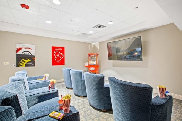 Comfortable seating in a common area with a TV and popcorn
