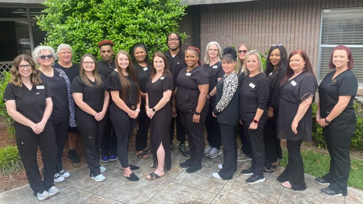 Group photo of staff outside the facility