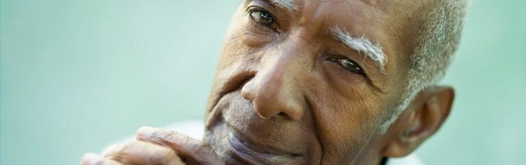 Close-up of an elderly man with a thoughtful expression