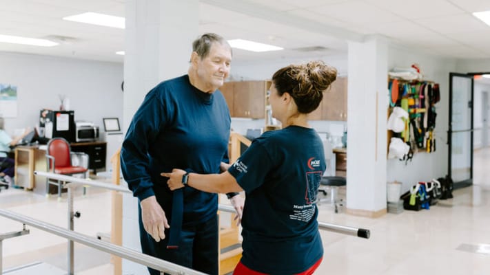 Therapist assisting a resident during rehabilitation