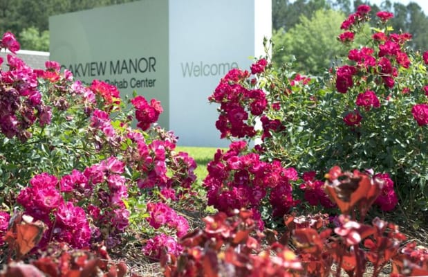 Colorful flowers in front of Oakview Manor sign