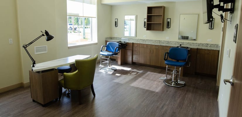 Bright interior view of a salon area with stylist chairs