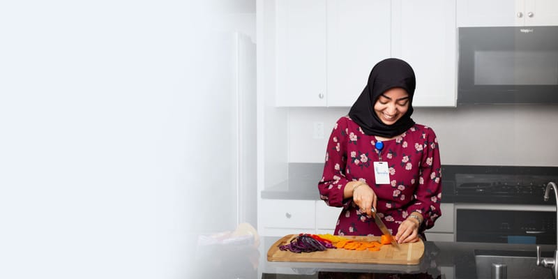 Staff member preparing food in a kitchen