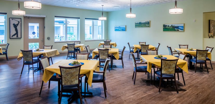 Bright dining room with tables set for meals
