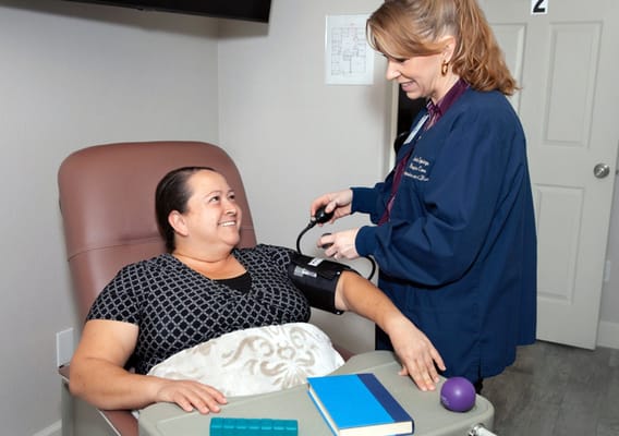 Healthcare staff taking a resident's blood pressure