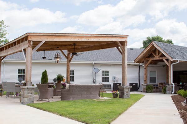 Outdoor patio area with seating and landscaping