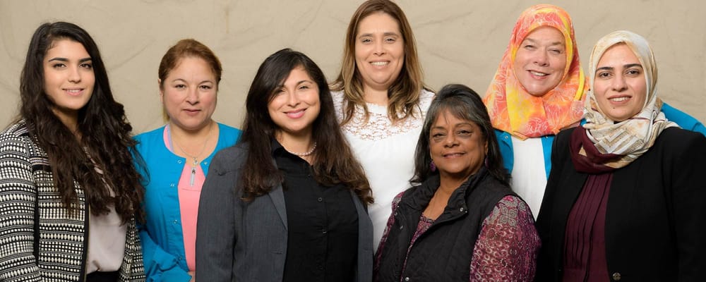 Diverse staff smiling in a group photo