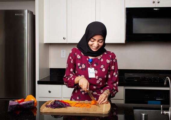Staff member preparing vegetables in the kitchen