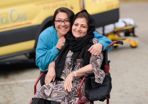 Staff member assisting a resident in a wheelchair