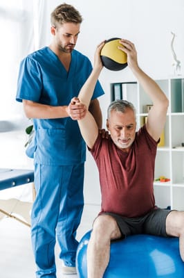 Therapist assisting a resident with a balance exercise