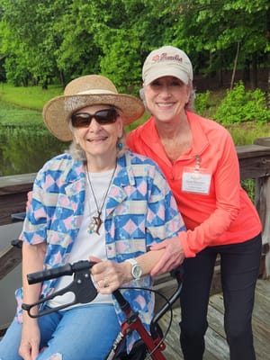 A caregiver and resident enjoying time outdoors