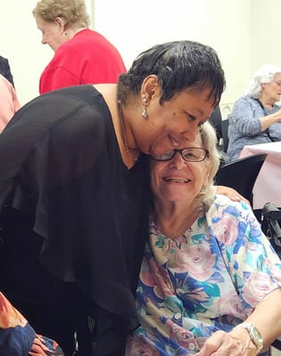 Residents enjoying a warm moment together in an activity room