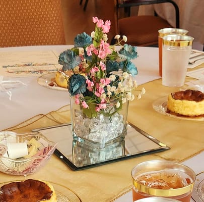 Table setting with desserts and decorative flowers