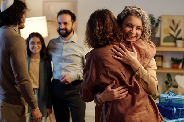 Residents and staff embracing in a warm gathering