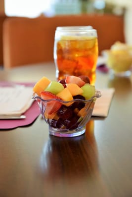 A bowl of fresh fruit salad on a dining table