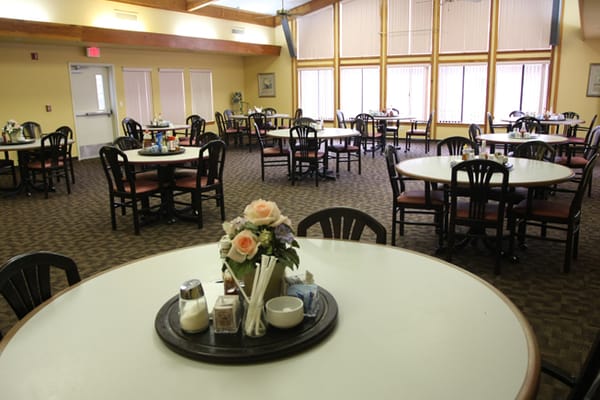 Dining room with tables set for residents