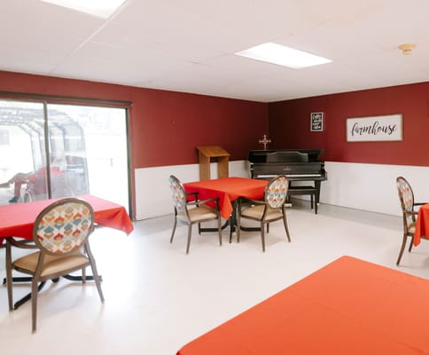 Common area with tables and a piano