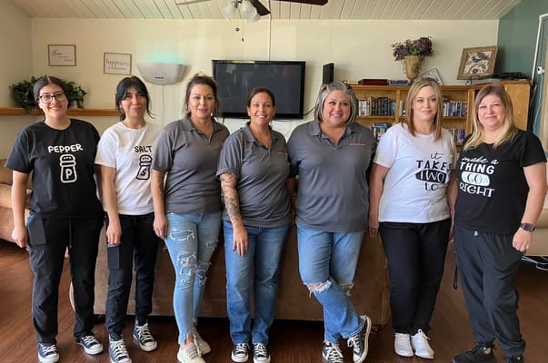 Staff members posing together in a common area
