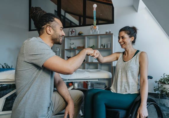 Therapist encouraging a resident in a rehabilitation session